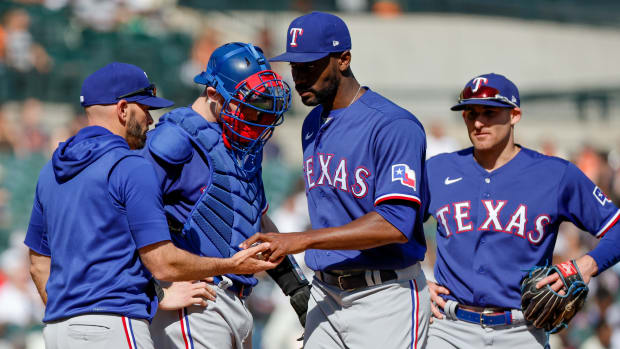 Jun 18, 2022; Detroit, Michigan, USA; Texas Rangers manager Chris Woodward take the ball to relieve starting pitcher Taylor Hearn (52) in the fourth inning against the Detroit Tigers at Comerica Park. Mandatory Credit: Rick Osentoski-USA TODAY Sports